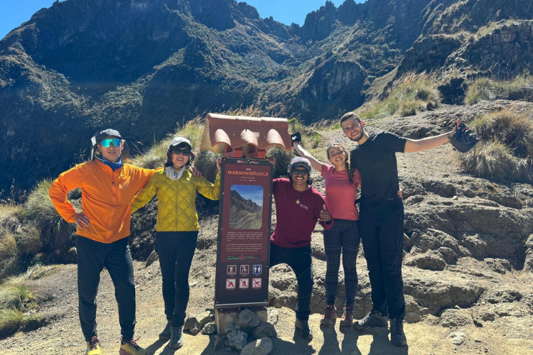 Group of travelers at Dead Woman Pass, the highest point of the Inca Trail to Machu Picchu, enjoying breathtaking views and an unforgettable adventure