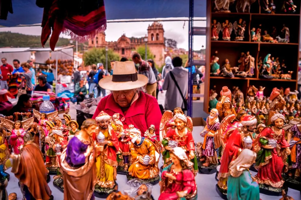 Colorful artisan stalls at Santurantikuy Christmas market in Cusco's Plaza de Armas, showcasing traditional crafts and holiday decorations