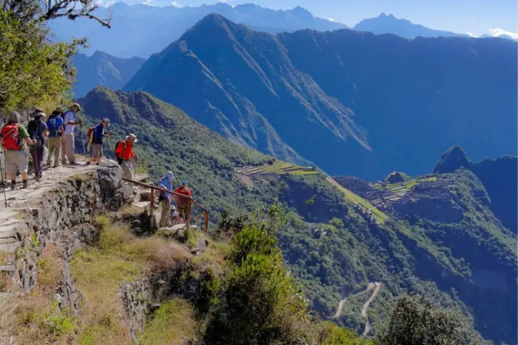 Trekkers reaching Machu Picchu with stunning views of the ancient citadel.